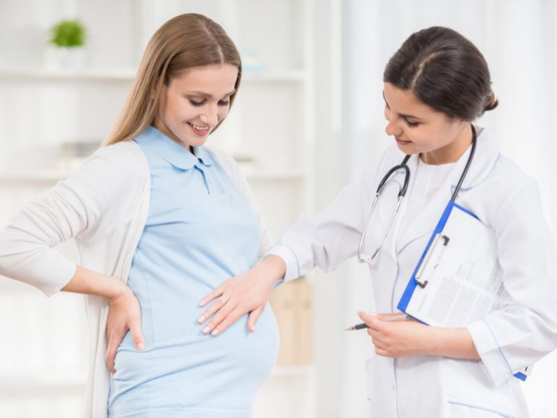 médica acariciando vientre de embarazada